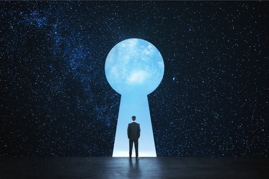 Man walking through dream-shaped door against starry background.