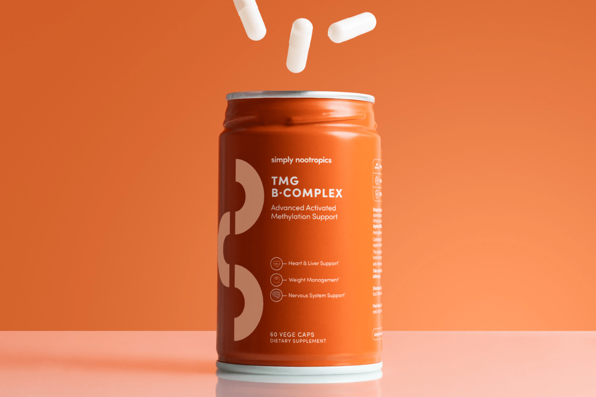 TMG B-Complex supplement bottle on an orange background.