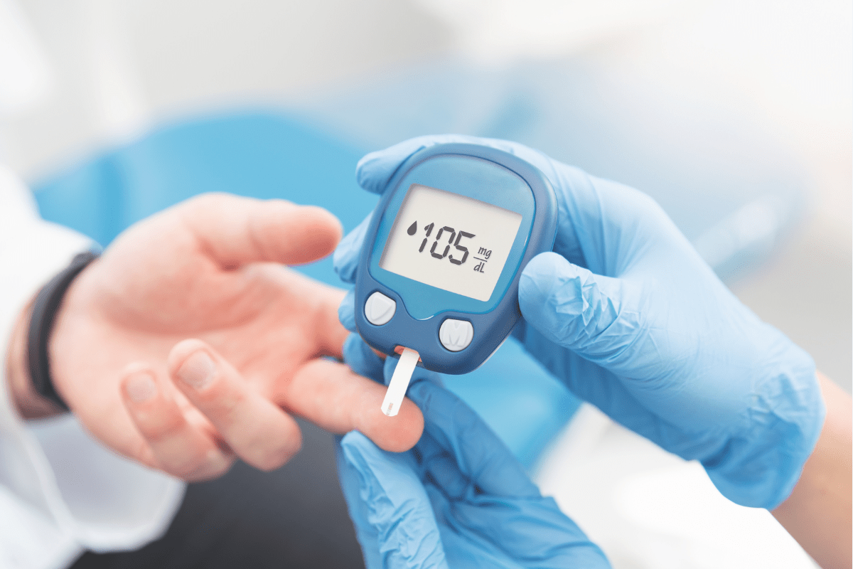 Blood glucose monitor showing 105 mg/dL reading.