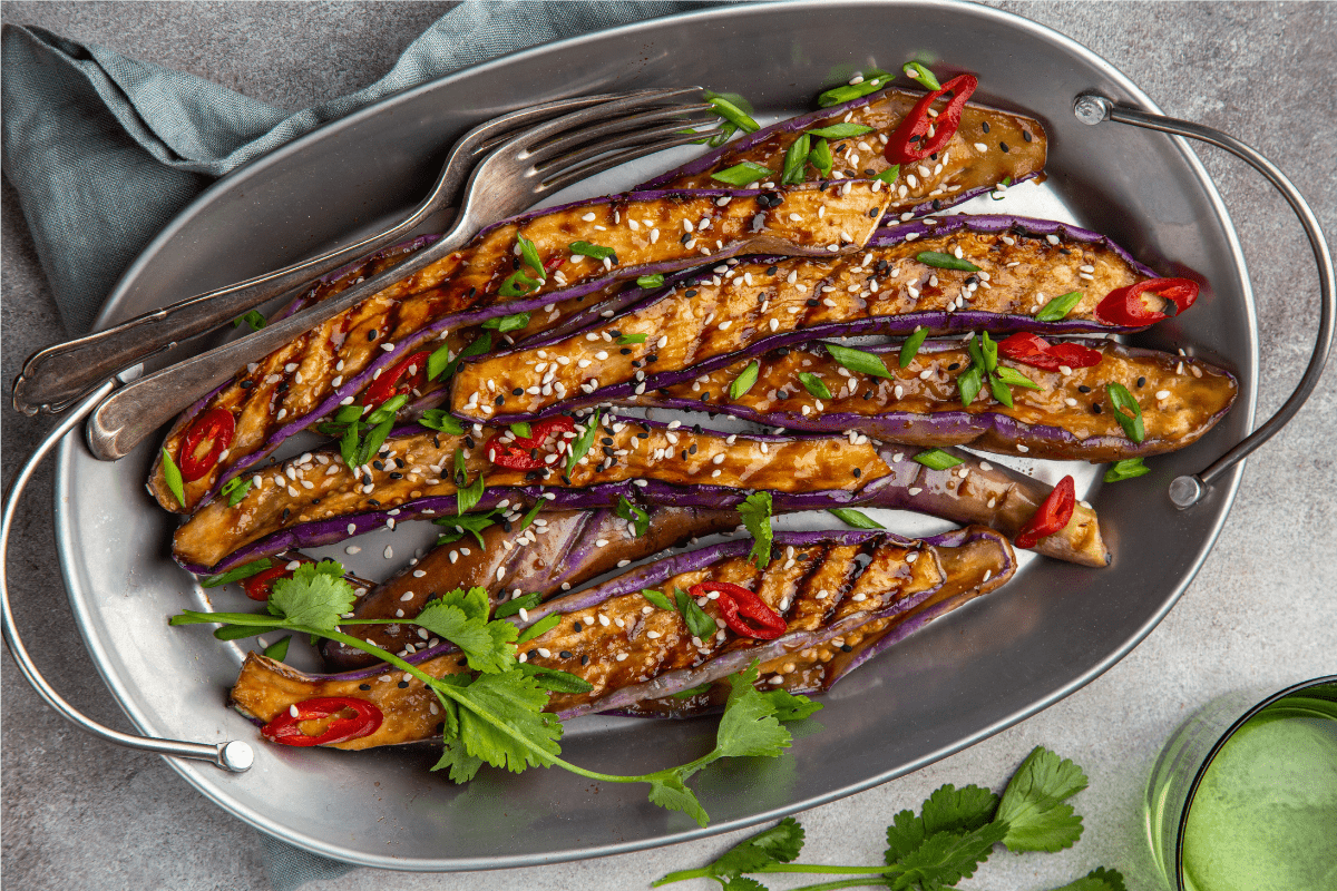 Glazed eggplant steaks with sesame seeds and cilantro.