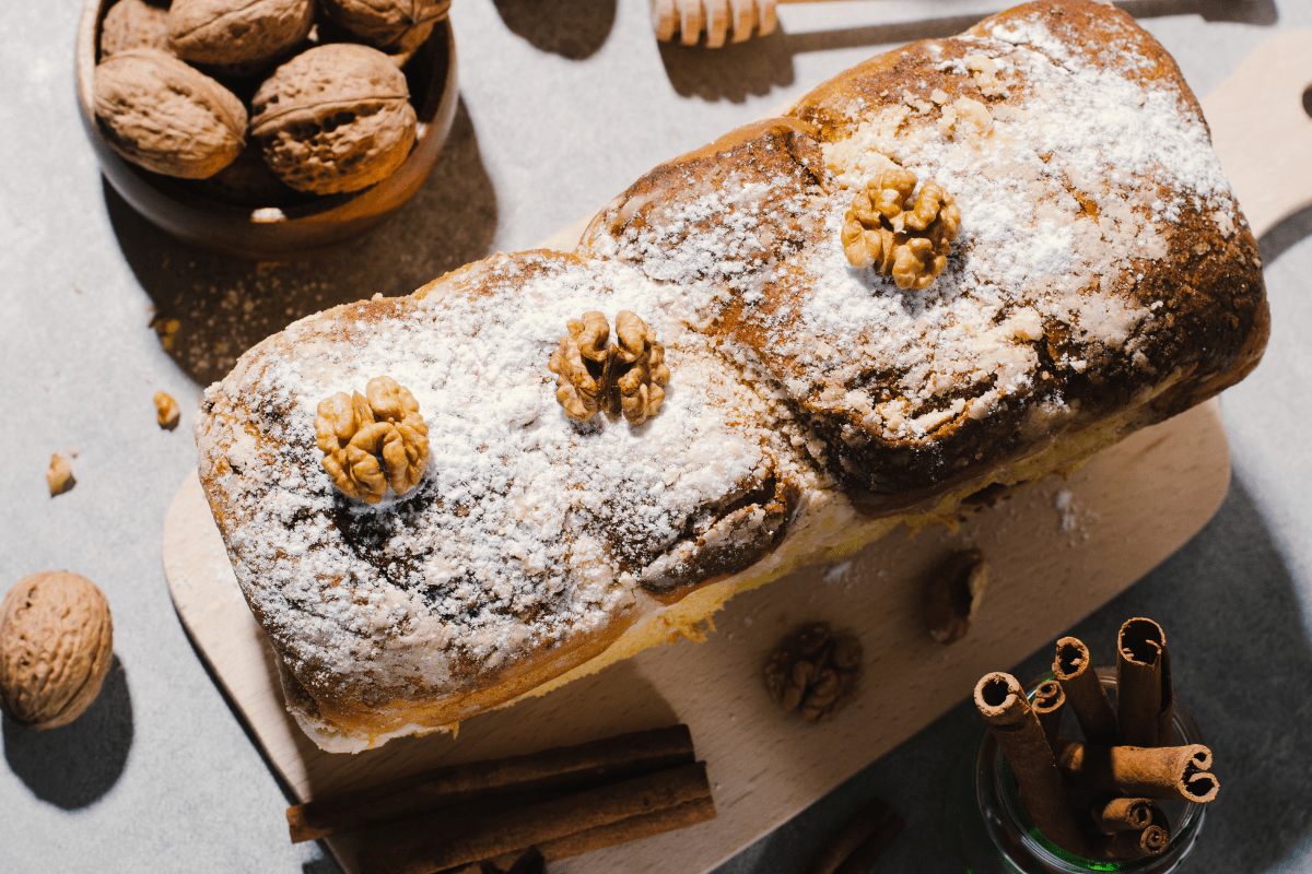 Golden-brown walnut loaf on a wooden board.